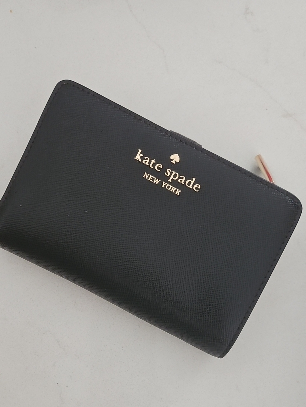 kate spade navy blue zip-around wallet with gold logo